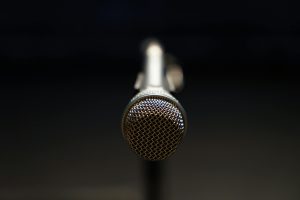 Mentoring Detailed close-up of a microphone in focus, ideal for music and broadcasting themes.