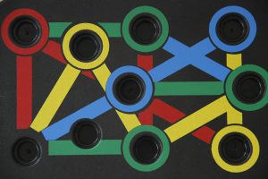 Mentoring Colorful geometric abstract art featuring interlinked circles and lines on a dark background.